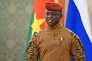 Captain Ibrahim Traoré in front of Burkina Faso's flag.